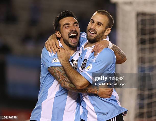 Rodrigo Palacio of Argentina celebrates with teammate Ezequiel Lavezzi after scoring during a match between Argentina and Peru as part of the 17th...