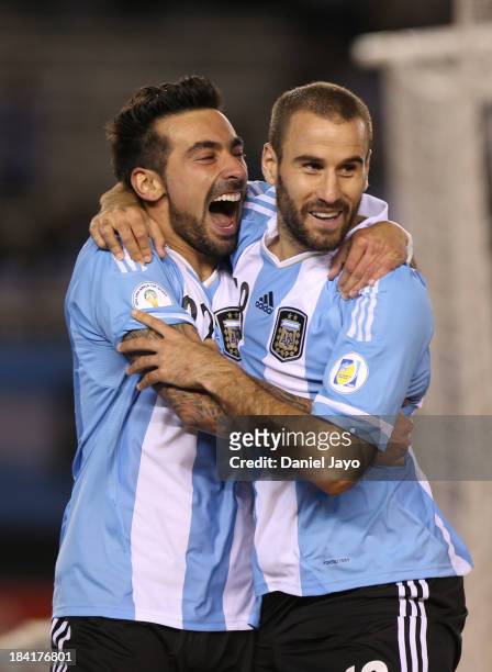 Rodrigo Palacio of Argentina celebrates with teammate Ezequiel Lavezzi after scoring during a match between Argentina and Peru as part of the 17th...