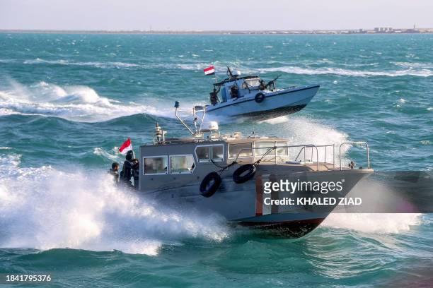 Yemeni coastguard members loyal to the internationally-recognised government ride in a speedboat and a patrol boat cruising in the Red Sea off of the...