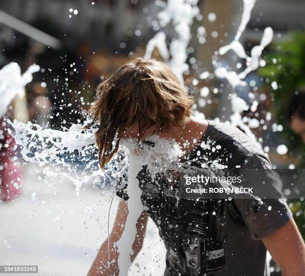 Kasey Yale cools off by putting his face in a water fountain in the Hollywood and Highland complex in Los Angeles on September 27, 2010. The mercury...