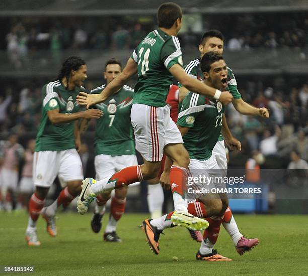Footballer Raul Jimenez of Mexico celebrates with teammates after scoring the second goal of the team against Panama during the Brazil 2014 FIFA...