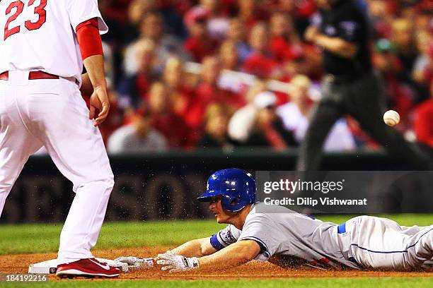 Mark Ellis of the Los Angeles Dodgers slides into third on a triple in the 10th inning against the St. Louis Cardinals during Game One of the...