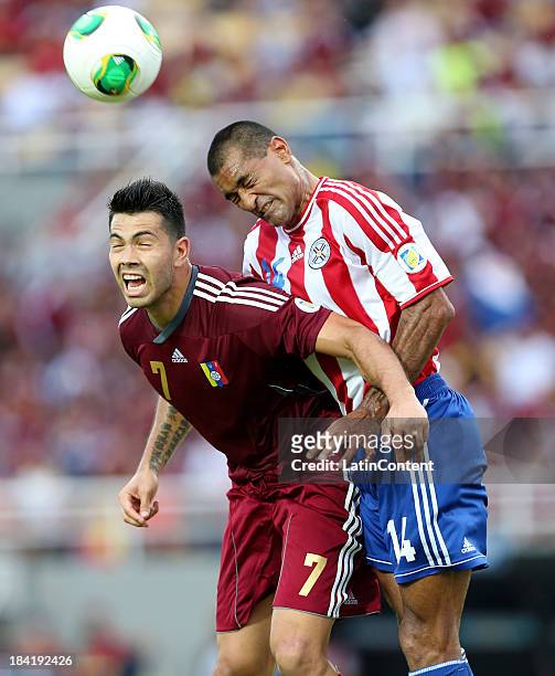 Nicolas Fedor and Paulo Da Silva fight fot the ball during the match between Venezuela and Paraguay as part of the 17th round of the South American...