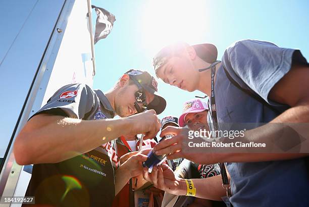 Casey Stoner driver of the Red Bull Pirtek Holden signs autographs prior to the Bathurst round of the Dunlop Series at Mount Panorama on October 12,...