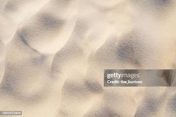 full frame shot of sand area on the beach, abstract background - areia imagens e fotografias de stock