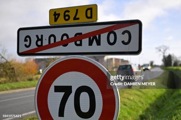 Photograph taken in Combourg on December 12, 2023 shows a road sign indicating the exit of the French city of Guipel, western France, which has been...