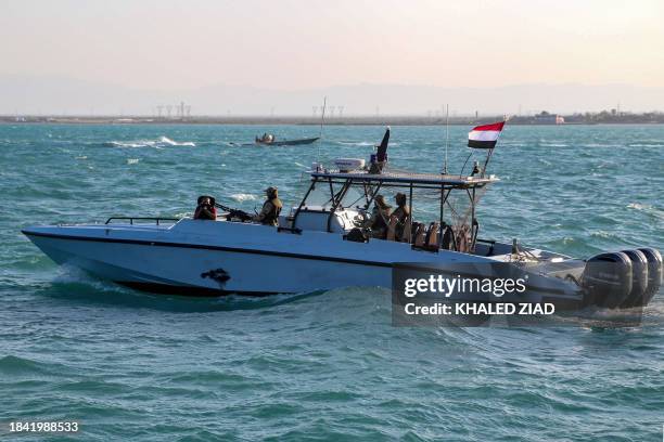 Yemeni coastguard members loyal to the internationally-recognised government ride in a patrol boat in the Red Sea off of the government-held town of...