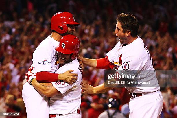 David Freese and Daniel Descalso and Matt Holliday of the St. Louis Cardinals celebrate their to 2 win over the Los Angeles Dodgers in Game One of...