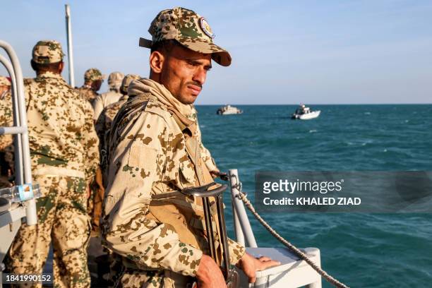 Yemeni coastguard member loyal to the internationally-recognised government rides in a patrol boat in the Red Sea off of the government-held town of...
