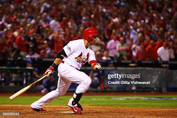 Carlos Beltran of the St. Louis Cardinals hits the game winning run in the 13th inning against the Los Angeles Dodgers during Game One of the...