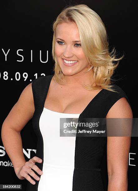 Actress Emily Osment arrives at the Los Angeles premiere of 'Elysium' at Regency Village Theatre on August 7, 2013 in Westwood, California.