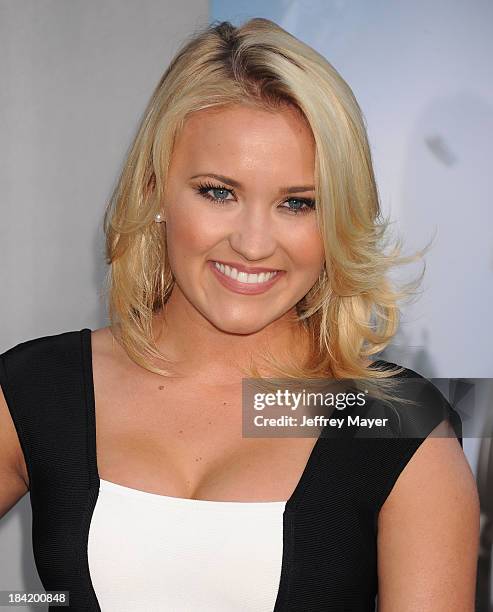 Actress Emily Osment arrives at the Los Angeles premiere of 'Elysium' at Regency Village Theatre on August 7, 2013 in Westwood, California.