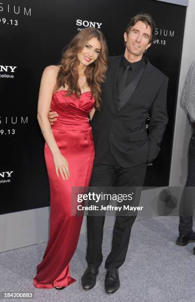 Actor Sharlto Copley and model Tanit Phoenix arrive at the Los Angeles premiere of 'Elysium' at Regency Village Theatre on August 7, 2013 in...