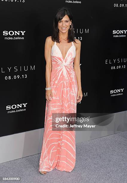 Actress Perrey Reeves arrives at the Los Angeles premiere of 'Elysium' at Regency Village Theatre on August 7, 2013 in Westwood, California.