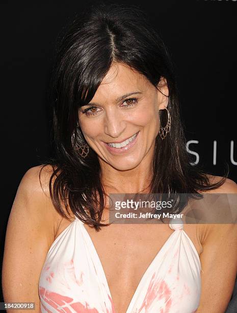 Actress Perrey Reeves arrives at the Los Angeles premiere of 'Elysium' at Regency Village Theatre on August 7, 2013 in Westwood, California.
