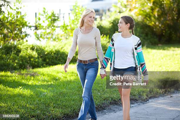 mom and teenage daughter walking together - 13 year old girls in shorts stock pictures, royalty-free photos & images