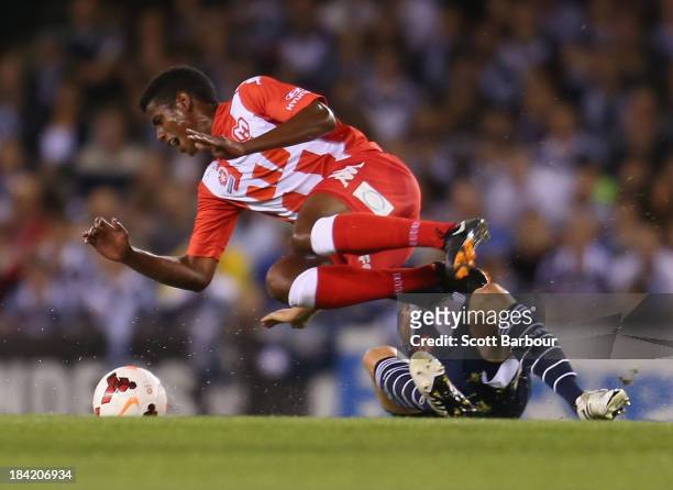 Golgol Mebrahtu of the Heart is fouled by Adrian Leijer of the Victory during the round one A-League match between the Melbourne Victory and the...