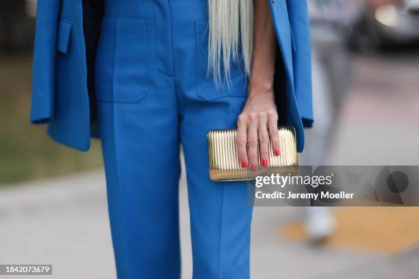 Denisa Palsha seen wearing Victoria Beckham blue suit blazer jacket and matching Victoria Beckham blue long suit pants and vintage gold metallic...