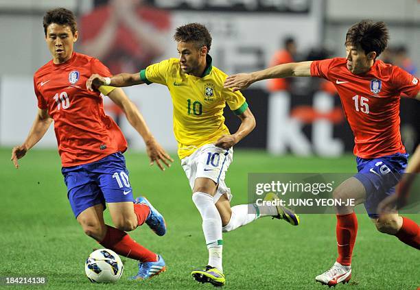 Brazilian forward Neymar vies for the ball with South Korean midfielder Kim Bo-Kyung and forward Koo Ja-Cheol during a friendly football match in...