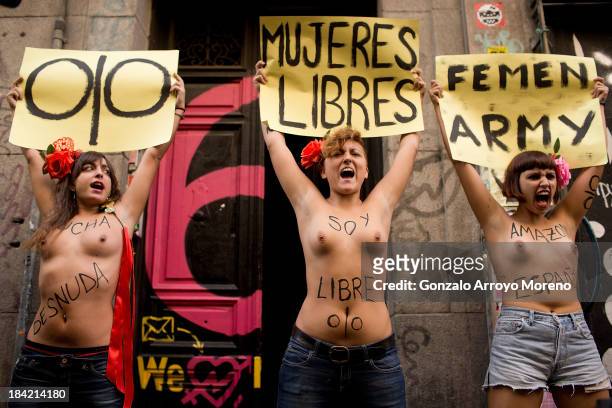 Activists from the feminist group FEMEN protest at the front door of Patio Maravillas where they have placed their headquarters with femenist sings...