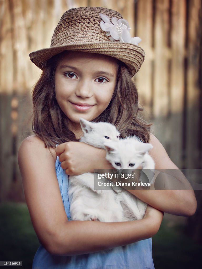 Girl with two white kittens