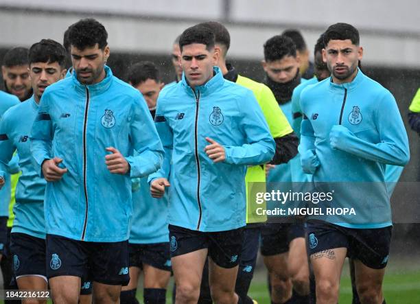 Porto's Spanish forward Fran Navarro jogs beside FC Porto's Iranian forward Mehdi Taremi and FC Porto's Argentine midfielder Alan Varela take part...