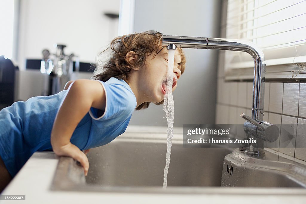 Small boy drinking water