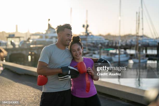 fit woman having a laugh with boxing instructor - boxing womens stock pictures, royalty-free photos & images