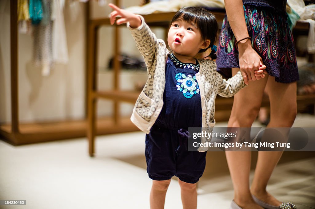 Toddler girl pointing at something far away