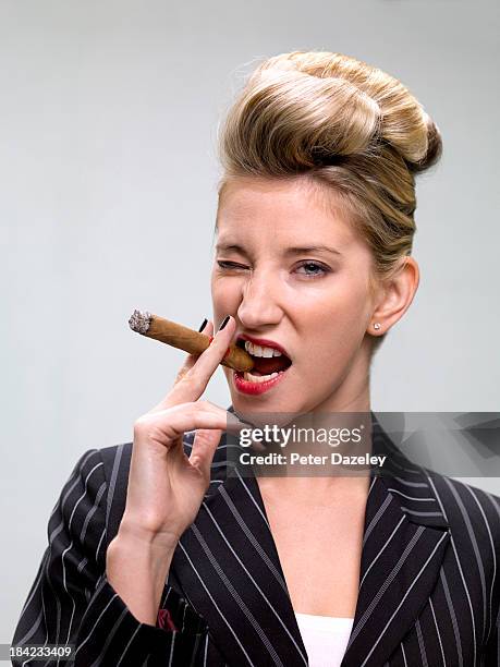 businesswoman smoking cigar - arrogance stock pictures, royalty-free photos & images