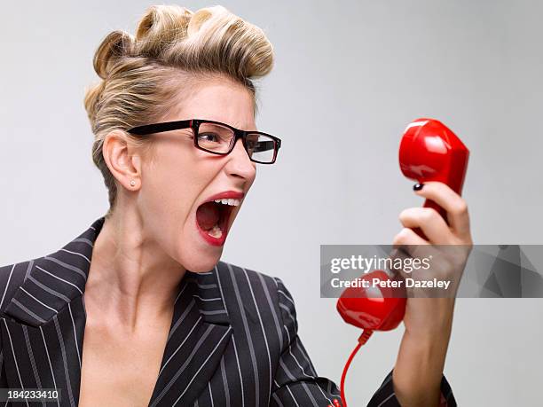 businesswoman screaming down phone - phone receiver stock pictures, royalty-free photos & images
