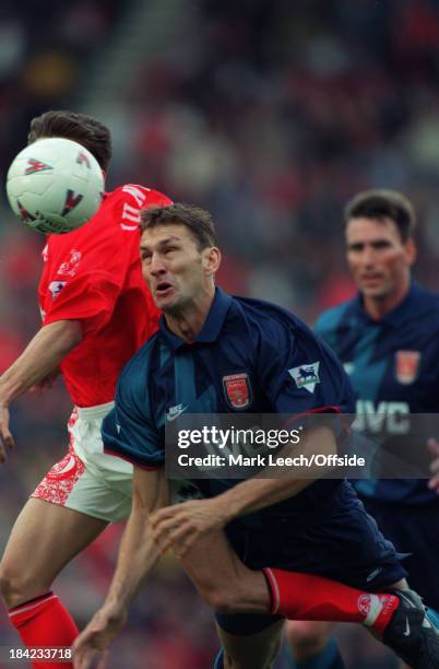 September 1996 - English Football Premier League - Middlesbrough v Arsenal - Tony Adams of Arsenal leaps in the air for the header with Juninho of...