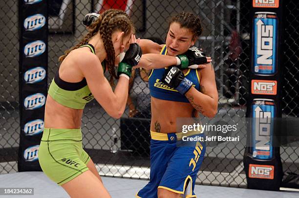 Raquel Pennington punches Jessamyn Duke in their preliminary fight during filming of season eighteen of The Ultimate Fighter on June 17, 2013 in Las...