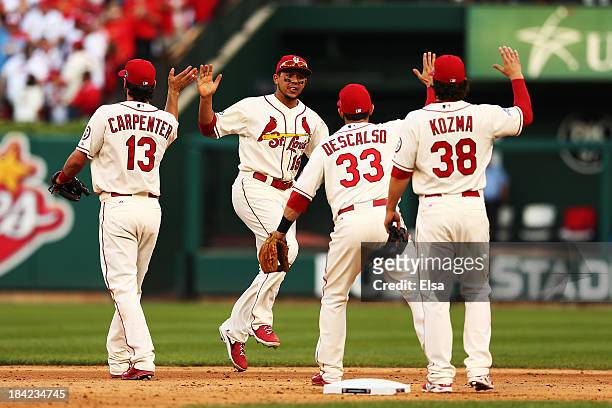 Matt Carpenter, Jon Jay, Daniel Descalso and Pete Kozma of the St. Louis Cardinals celebrate their 1 to 0 win over the Los Angeles Dodgers during...