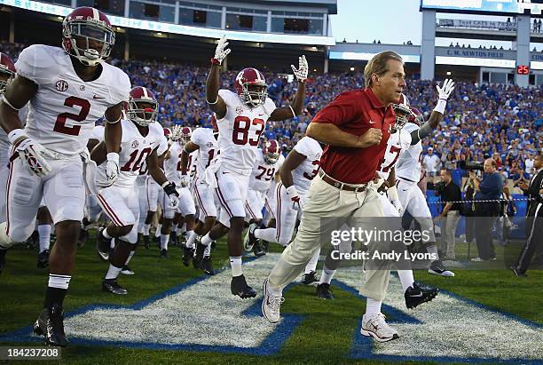 Nick Saban the head coach of the Alabama Crimson Tide leads his team on the field before the game against the Kentucky Wildcats at Commonwealth...