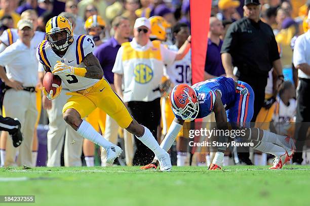Odell Beckham Jr. #3 of the LSU Tigers catches a pass in front of Loucheiz Purifoy of the Florida Gators during a game at Tiger Stadium on October...