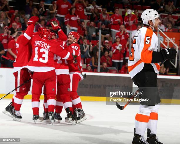 Braydon Coburn of the Philadelphia Flyers skates to the bench as Jonathan Ericsson, Niklas Kronwall, Pavel Datsyuk and Henrik Zetterberg of the...