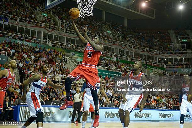 Tony Snell of the Chicago Bulls shoots over Glen Rice, Jr. #14 of the Washington Wizards during Chicago Bulls v Washington Wizards - NBA Global Games...