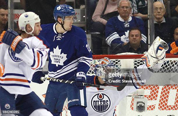 Edmonton Oilers goalie Devan Dubnyk makes a glove cave in front of James van Riemsdyk and Edmonton Oilers left wing Ryan Smyth as the Toronto Maple...