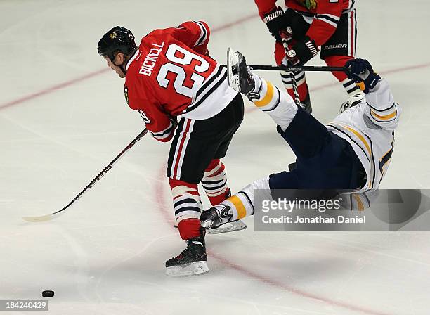 Cody Hodgson of the Buffalo Sabres goes flying in the air after colliding with Bryan Bickell of the Chicago Blackhawks at the United Center on...