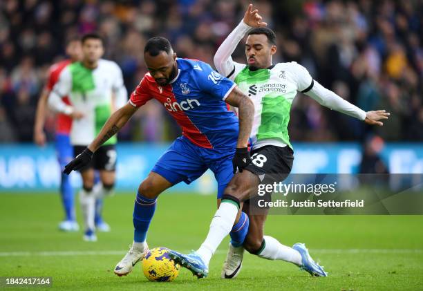 Jordan Ayew of Crystal Palace is challenged by Ryan Gravenberch of Liverpool during the Premier League match between Crystal Palace and Liverpool FC...