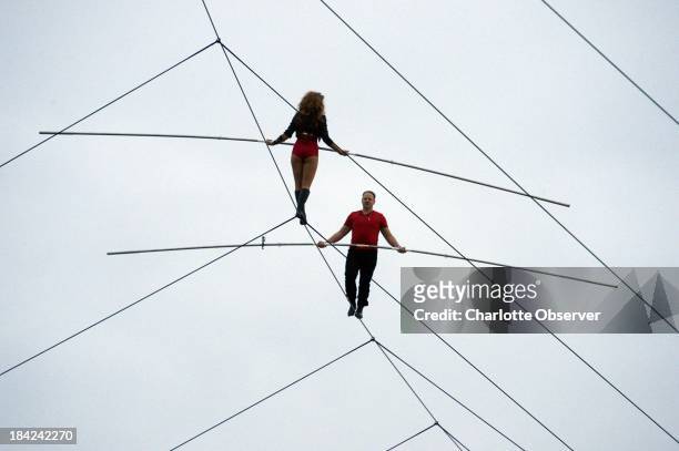 Nik Wallenda, right, walks the tightrope above Charlotte Motor Speedway on Saturday, October 12 with his sister, Lijana, 140 feet above pit road...