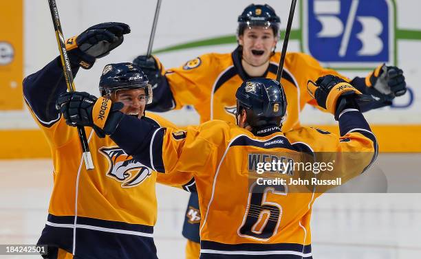 Seth Jones of the Nashville Predators celebrates his first NHL goal with Shea Weber against the New York Islanders at Bridgestone Arena on October...