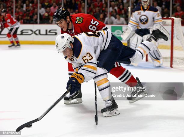 Tyler Ennis of the Buffalo Sabres controls the puck under pressure from Andrew Shaw of the Chicago Blackhawks at the United Center on October 12,...