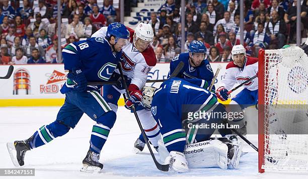 Dan Hamhuis of the Vancouver Canucks can't stop the puck from a shot by Max Pacioretty of the Montreal Canadiens from crossing the goal line behind...