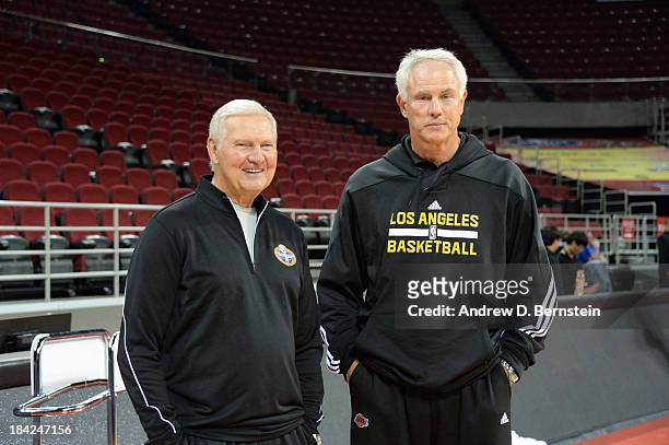 General Manager Mitch Kupchak of the Los Angeles Lakers speaks Jerry West of the Golden State Warriors after practice as part of 2013 Global Games on...