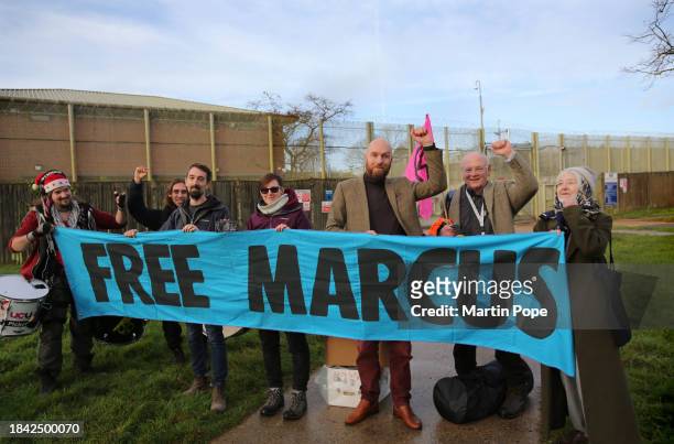 Morgan Trowland remembers his colleague Marcus Decker who is still in prison by joining friends behind a banner saying 'Free Marcus' as he leaves...