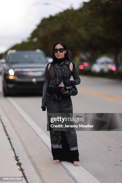 Miki Sui Cheung seen wearing Dior black sunglasses, Saint Laurent silver earrings, Jean Paul Gaultier black faded denim print pattern cut-outs long...