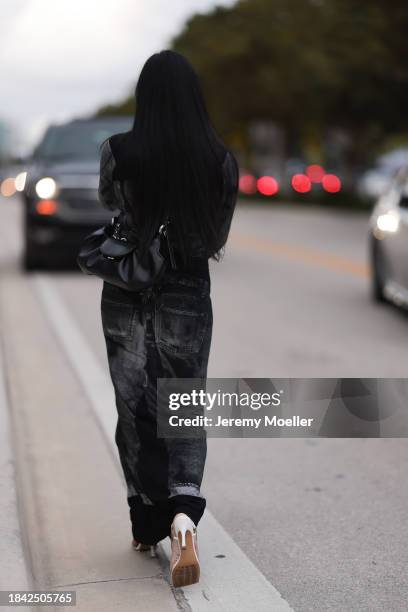 Miki Sui Cheung seen wearing Saint Laurent silver earrings, Jean Paul Gaultier black faded denim print pattern cut-outs long dress, THEMOIRè black...