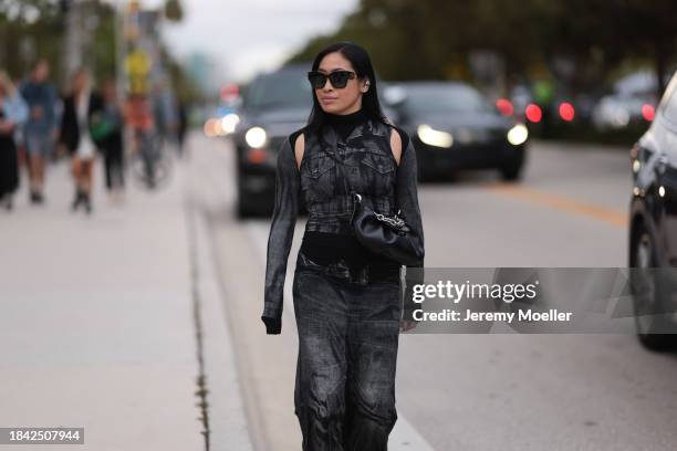 Miki Sui Cheung seen wearing Dior black sunglasses, Saint Laurent silver earrings, Jean Paul Gaultier black faded denim print pattern cut-outs long...